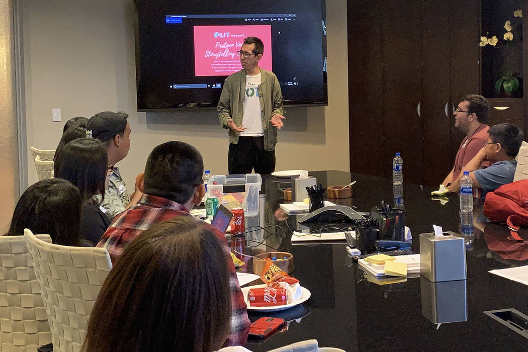 Alan Cruz performs his poem in front of a crowd at R&R Partners on Thursday, July 27 in prepara ...