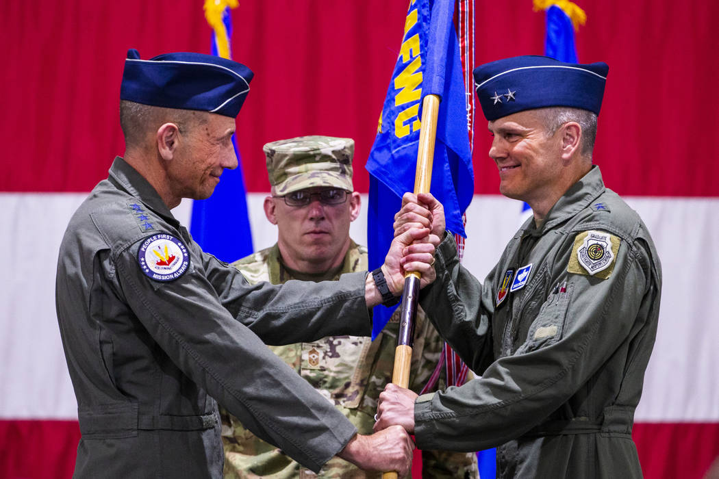 Gen. Mike Holmes, Commander of Air Combat Command, left, hands over the command flag to Maj.Gen ...