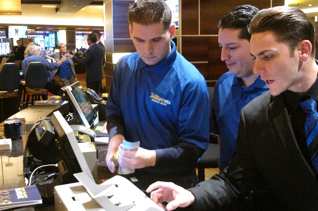 Employees at the sports book at the Tropicana casino in Atlantic City, N.J., count money moment ...