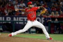 Los Angeles Angels relief pitcher Felix Pena throws to a Seattle Mariners batter during the six ...