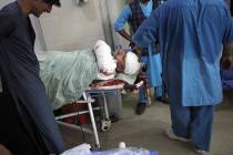 A wounded man receives treatment in a hospital after a suicide attack on the outskirts of Nanga ...
