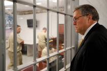 Attorney General William Barr watches as inmates work in a computer class during a tour of a fe ...