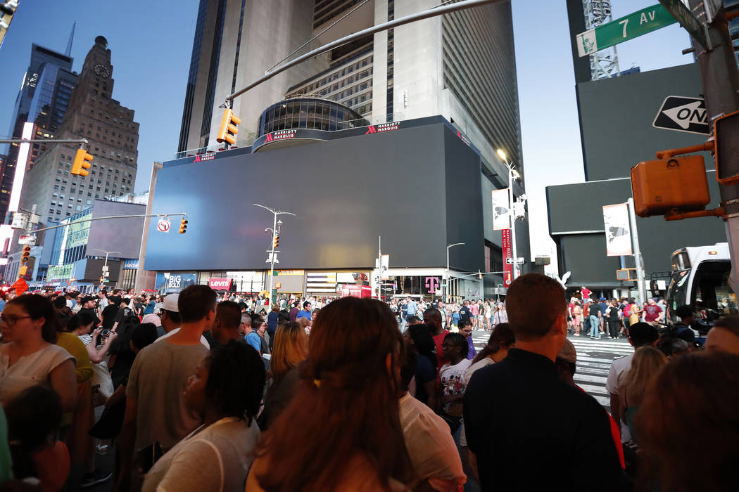Screens in Times Square are black during a widespread power outage, Saturday, July 13, 2019, in ...