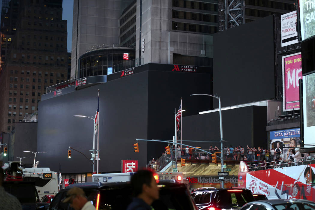 Screens in Times Square are black during a widespread power outage, Saturday, July 13, 2019, in ...