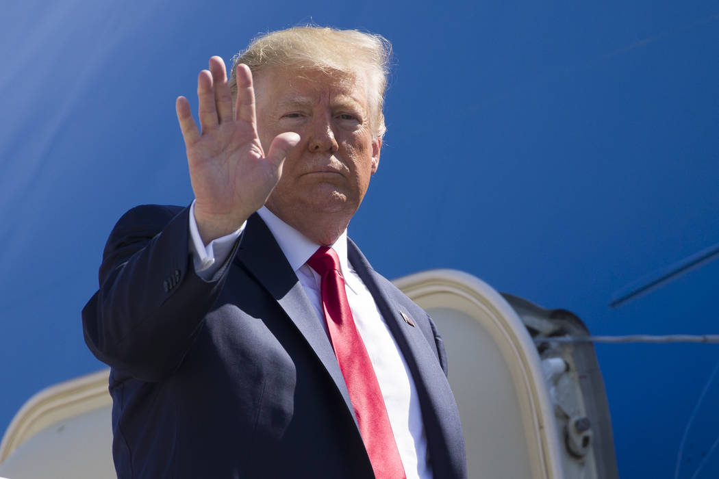 President Donald Trump waves as he boards Air Force One as he departs Friday, July 12, 2019, at ...