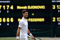 Serbia's Novak Djokovic smiles after defeating Switzerland's Roger Federer during the men's sin ...