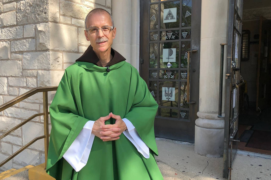 Rev. John Celichowski poses outside of the Saint Clare of Montefalco Catholic Church in Chicago ...