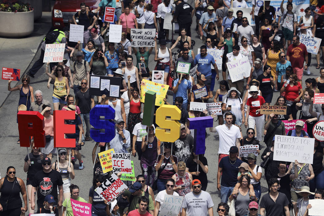 Thousands of people, including immigrants and their supporters, rally against President Trump's ...