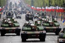 Tanks rolling on the Champs-Elysees avenue during the Bastille Day parade in Paris, France, Sun ...