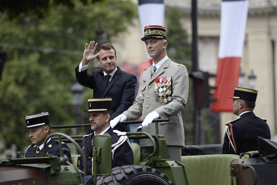 France's President Emmanuel Macron gestures in his command car next to French Armies Chief Staf ...