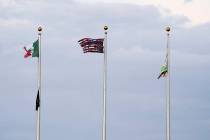This Friday, July 12, 2019, photo shows a Mexican flag, from left, an upside down U.S. flag wit ...