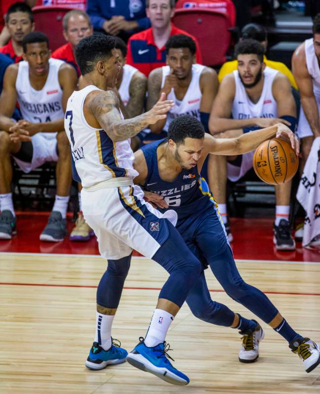 New Orleans Pelicans forward Marcos Louzada Silva, left, defends the lane as Memphis Grizzlies ...