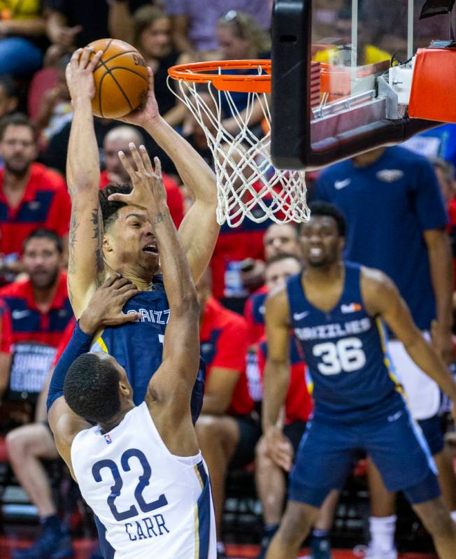 Memphis Grizzlies forward Brandon Clarke, left, goes unstrung to the basket over New Orleans Pe ...