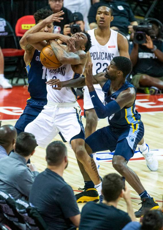 New Orleans Pelicans guard Nickeil Alexander-Walker, center, fights to keep the ball from Memph ...