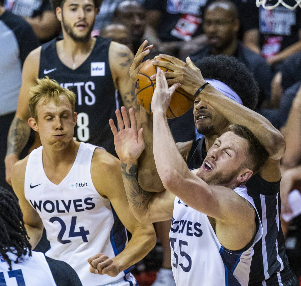 Minnesota Timberwolves forward Mitchell Creek, front right, battles for a loose ball with Brook ...