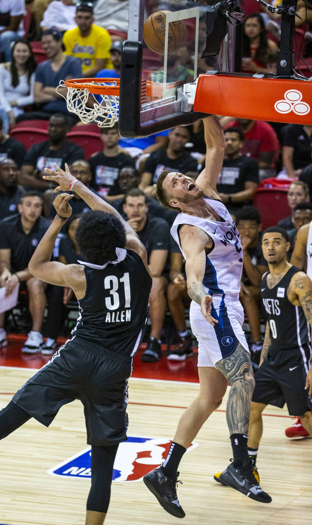 Brooklyn Nets center Jarrett Allen, left, is unable to defend a shot by Minnesota Timberwolves ...