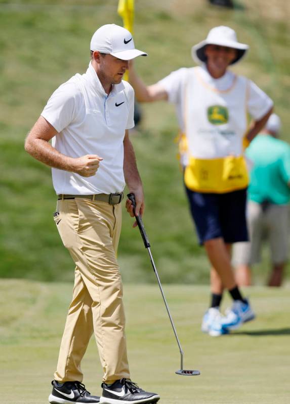 Russell Henley pumps his fist after making his birdie putt on the 18th green during the final r ...