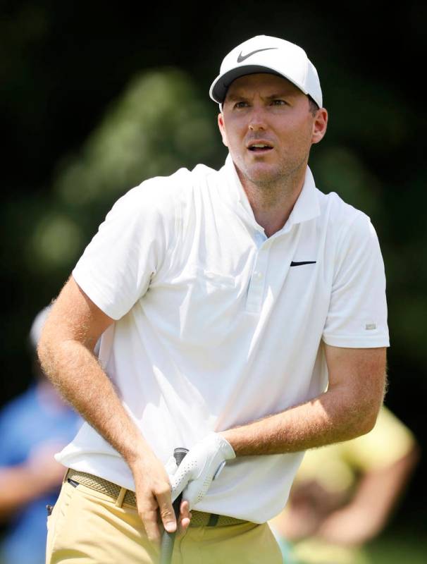 Russell Henley watches his shot off the 18th tee during the final round of the John Deere Class ...