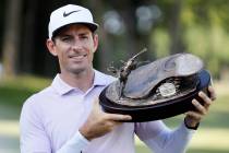 Dylan Frittelli holds the trophy after winning the John Deere Classic golf tournament, Sunday, ...