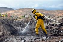 A firefighter hoses down an area in Reno in October 2016. (Mike Higdon/The Reno Gazette-Journal ...