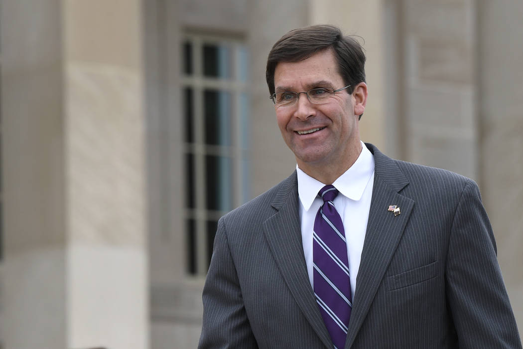 In this July 8, 2019, photo, acting Secretary of Defense Mark Esper waits for the arrival of Qa ...