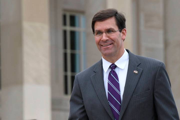 In this July 8, 2019, photo, acting Secretary of Defense Mark Esper waits for the arrival of Qa ...