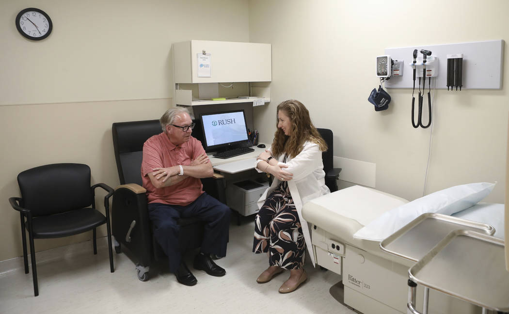In this July 9, 2019 photo, Dr. Jori Fleisher, neurologist, examines Thomas Doyle, 66, at the R ...