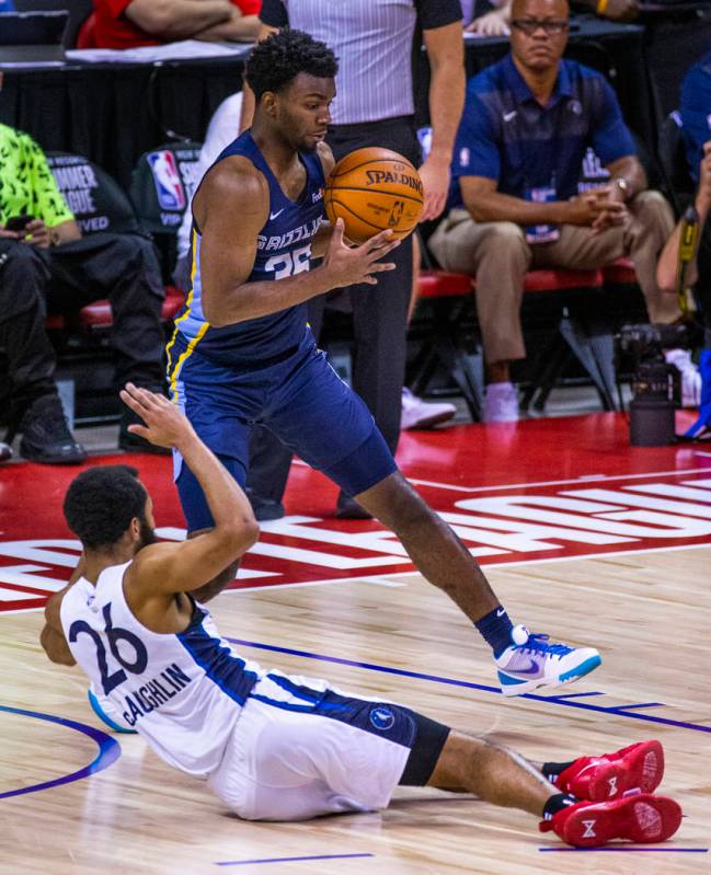 Memphis Grizzlies guard Keenan Evans, above, grabs a loose ball fumbled away by Minnesota Timbe ...
