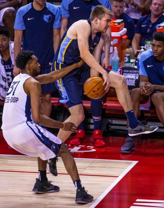 Minnesota Timberwolves forward Keita Bates-Diop, left, reaches in for a possible take away from ...