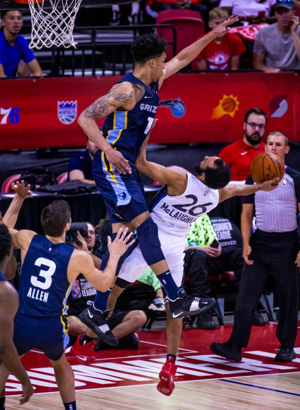 Memphis Grizzlies forward Brandon Clarke, above, gets up high to defend a shot from Minnesota T ...