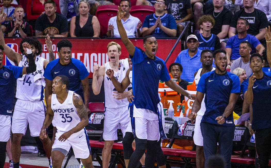 Minnesota Timberwolves' players cheer on their teammates as the close the gap versus the Memphi ...