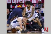 Minnesota forward Mitch Creek, below, sits on the ball after scrambling for it as Timberwolves ...