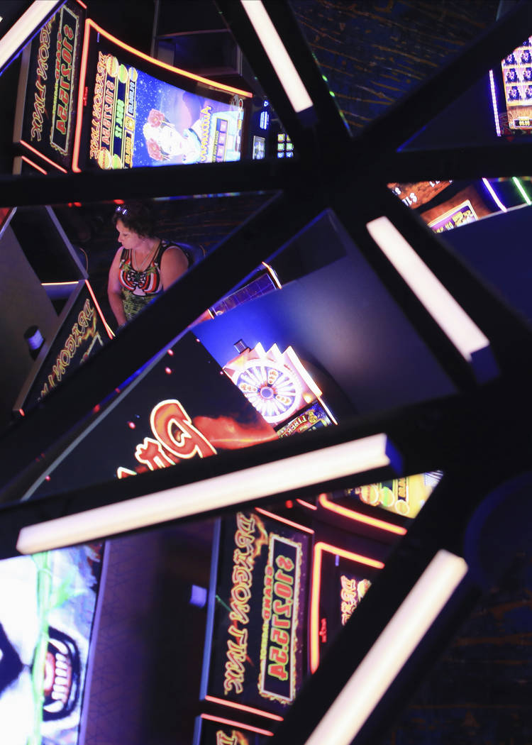 Slot machines are reflected in the ceiling of the Link Slot Lounge, a new gaming area at the St ...