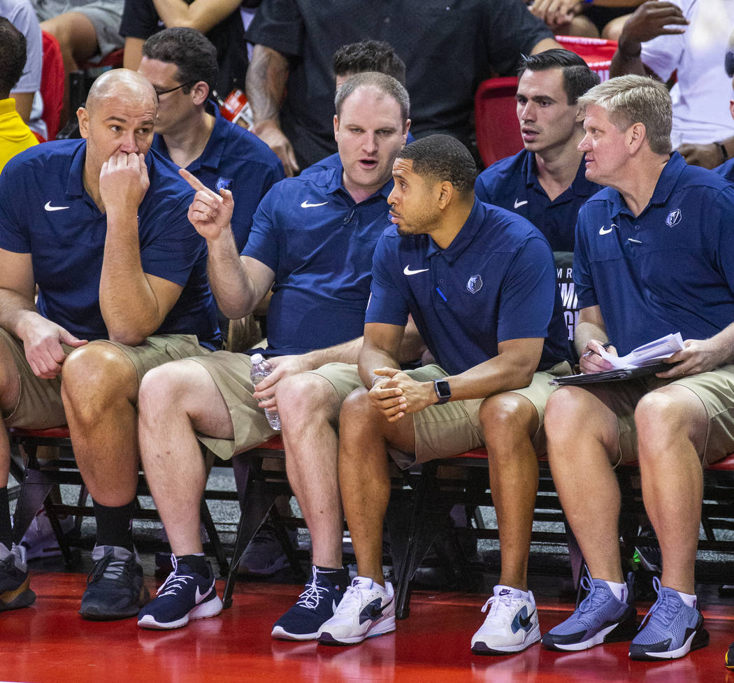 Memphis Grizzlies head coach Taylor Jenkins confers with his other coaches versus the Minnesota ...