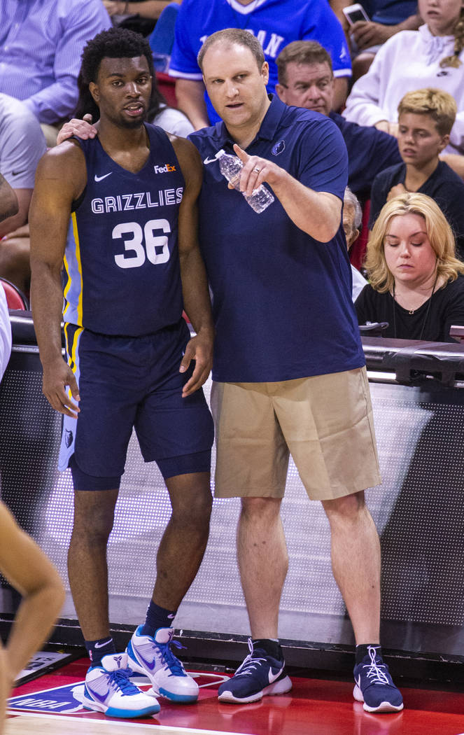 Memphis Grizzlies guard Keenan Evans, left, gets a few tips from his head coach Taylor Jenkins ...