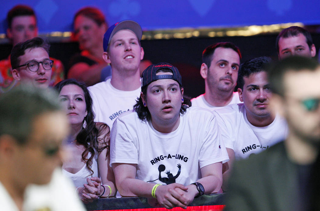 Fans of Kevin Maahs watch the main event final table at the World Series of Poker tournament at ...