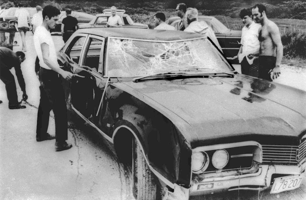 FILE - In this July 18, 1969 file photograph, curious onlookers inspect U.S. Sen. Edward Kenned ...