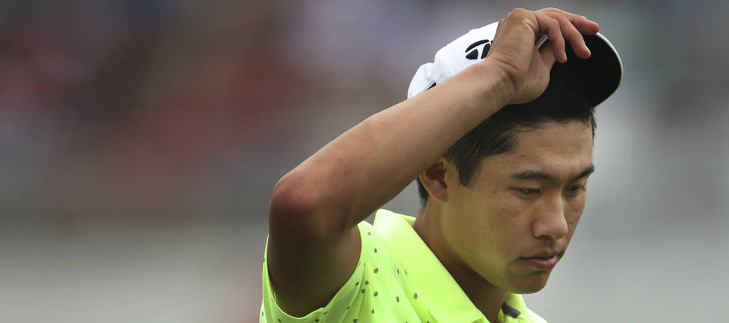 Collin Morikawa lifts his cap at 18 during the third round of the 3M Open golf tournament in Bl ...