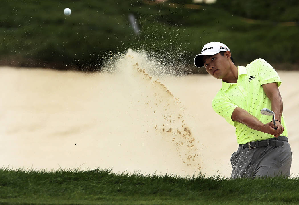 Collin Morikawa hits out of a bunker at 18 during the third round of the 3M Open golf tournamen ...