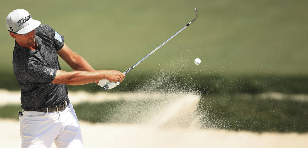 Collin Morikawa hits out bunker at seven during the third round of the 3M Open golf tournament ...