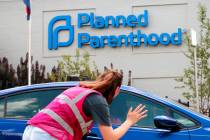 In a June 28, 2019, file photo, Ashlyn Myers of the Coalition for Life St. Louis, waves to a Pl ...