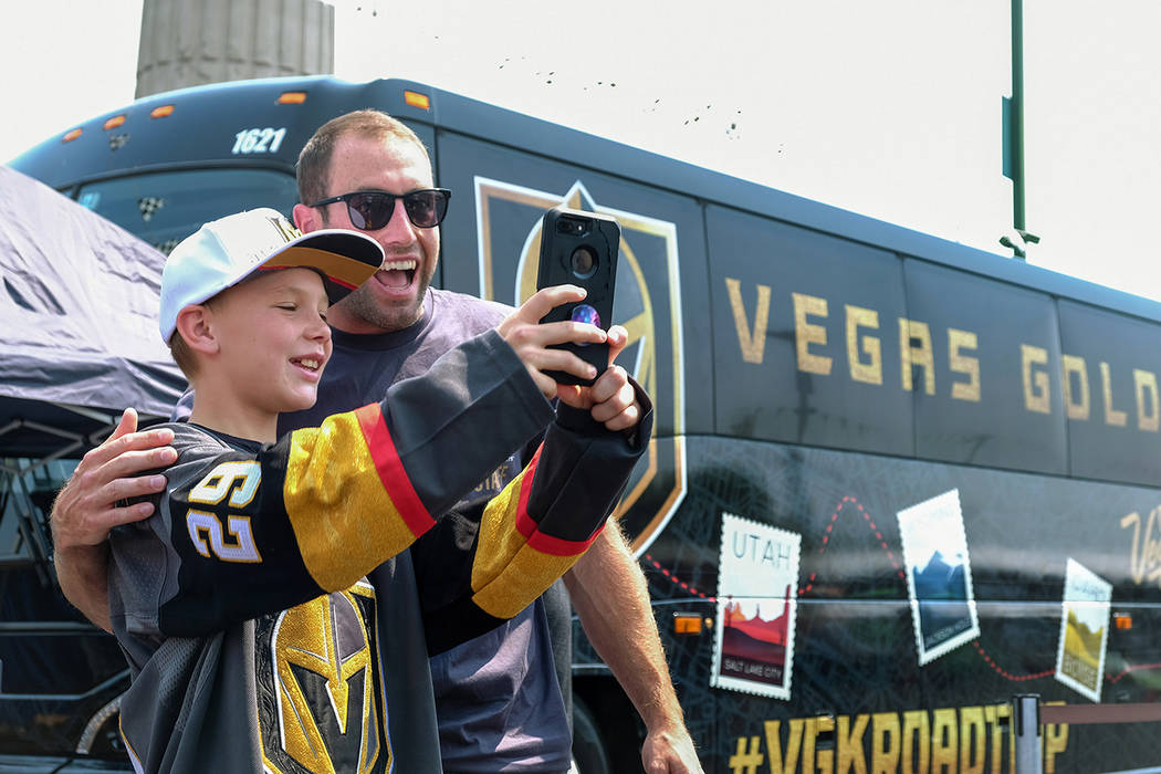 Former Golden Knights defenseman Brad Hunt takes a selfie with a young fan at a team event in ...