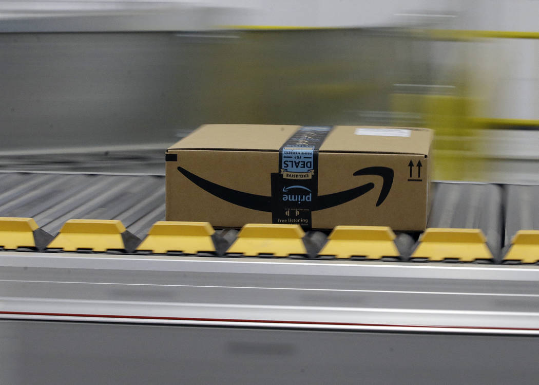 FILE - In this Feb. 9, 2018, file photo a box for an Amazon prime customer moves through the ne ...