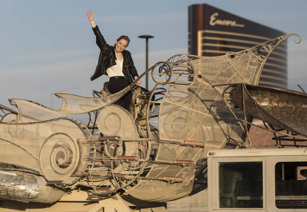 Rose Donahue waves at a friend from the top of the art installation "Balanceville" during the u ...