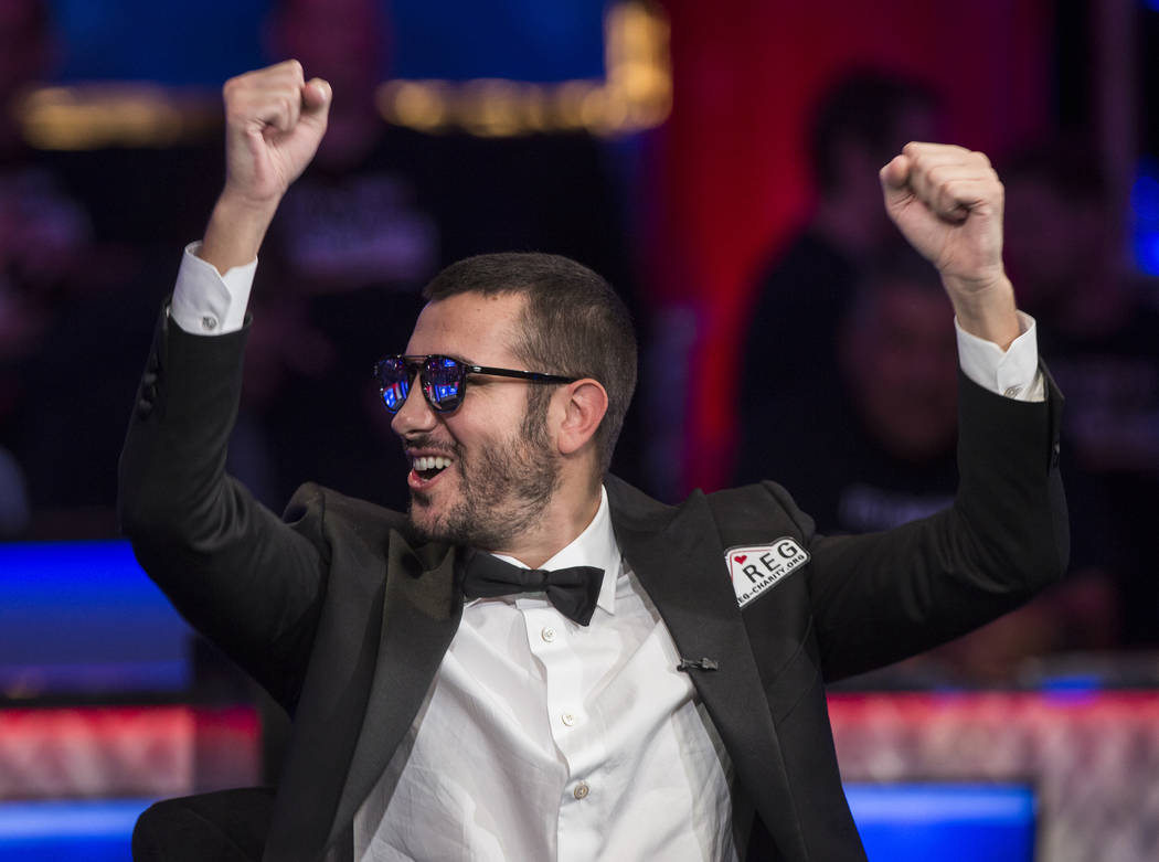 Dario Sammartino, from Italy, pumps his fists at fans during the World Series of Poker Main Eve ...