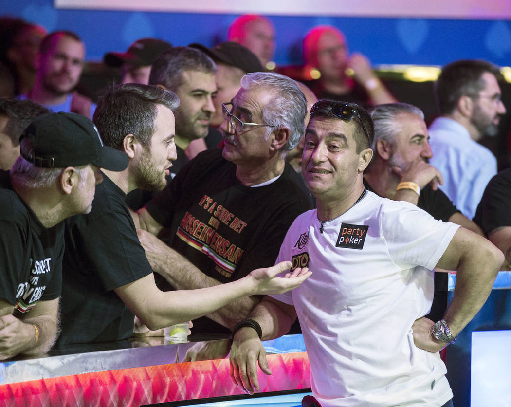 Hossein Ensan, right, from Germany, interacts with fans during the World Series of Poker Main E ...