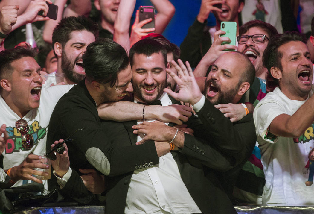 Dario Sammartino, middle, from Italy, celebrates with fans after advancing to the final two pla ...
