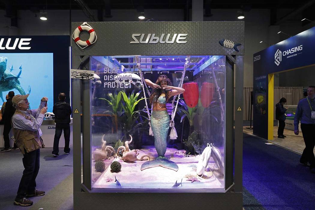 In this Jan. 9, 2019, file photo a woman dressed as a mermaid performs at the Sublue booth at C ...