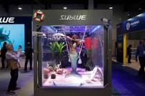 In this Jan. 9, 2019, file photo a woman dressed as a mermaid performs at the Sublue booth at C ...