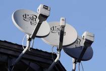 FILE - In this Feb. 23, 2011, file photo, Dish Network satellite dishes are shown at an apartme ...